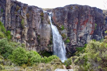 a large waterfall over a rocky cliff
