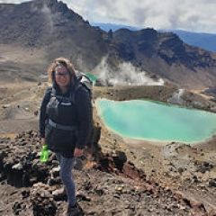 a person standing in front of a rocky mountain